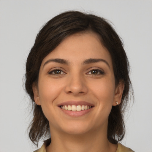 Joyful white young-adult female with medium  brown hair and brown eyes