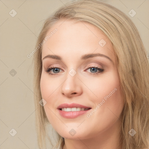 Joyful white young-adult female with long  brown hair and blue eyes