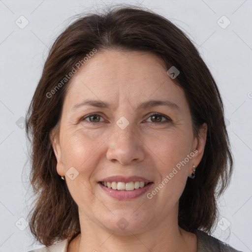 Joyful white adult female with medium  brown hair and brown eyes