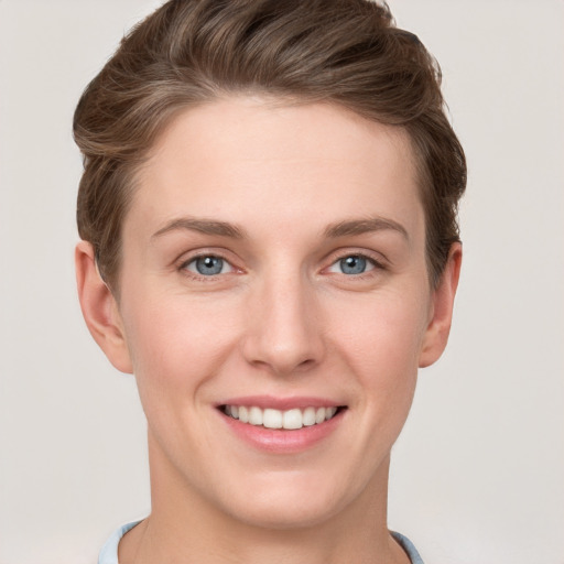 Joyful white young-adult female with short  brown hair and grey eyes