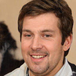 Joyful white adult male with short  brown hair and brown eyes