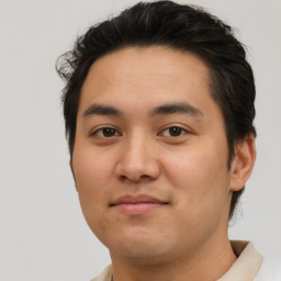 Joyful latino young-adult male with short  brown hair and brown eyes