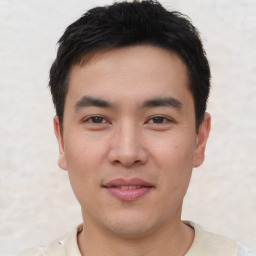 Joyful asian young-adult male with short  black hair and brown eyes