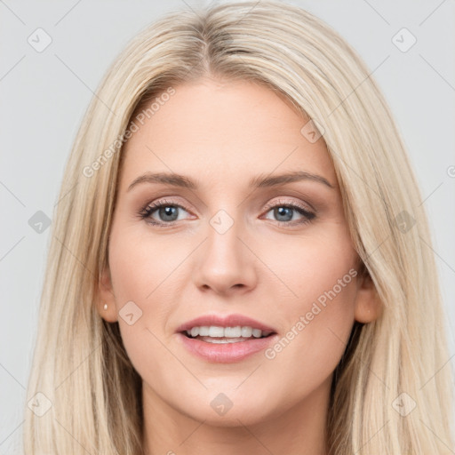 Joyful white young-adult female with long  brown hair and blue eyes