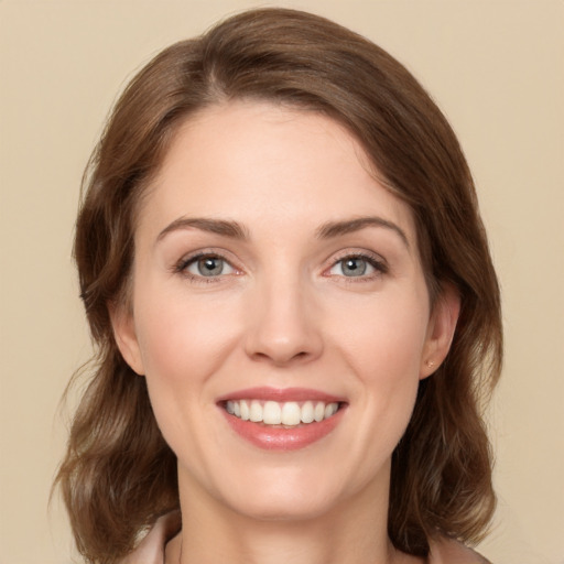 Joyful white young-adult female with medium  brown hair and green eyes