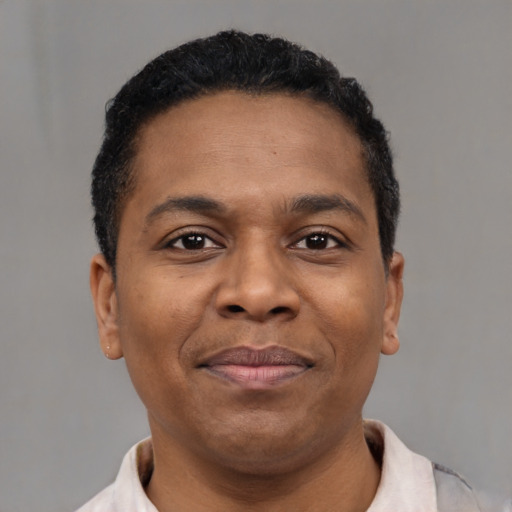 Joyful black adult male with short  brown hair and brown eyes