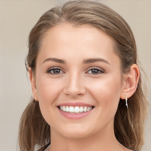 Joyful white young-adult female with long  brown hair and brown eyes