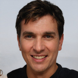 Joyful white adult male with short  brown hair and brown eyes