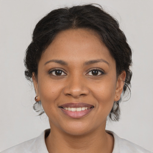 Joyful black young-adult female with medium  brown hair and brown eyes