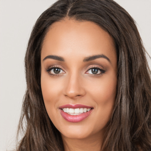 Joyful white young-adult female with long  brown hair and brown eyes