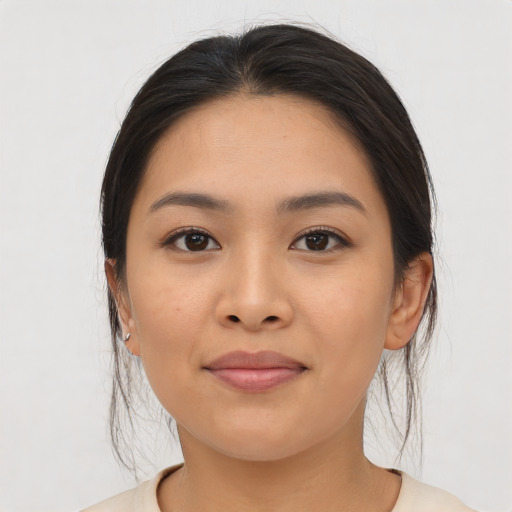 Joyful asian young-adult female with medium  brown hair and brown eyes