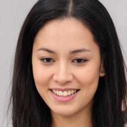 Joyful asian young-adult female with long  brown hair and brown eyes