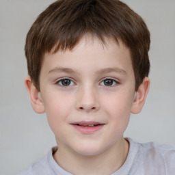 Joyful white child male with short  brown hair and brown eyes