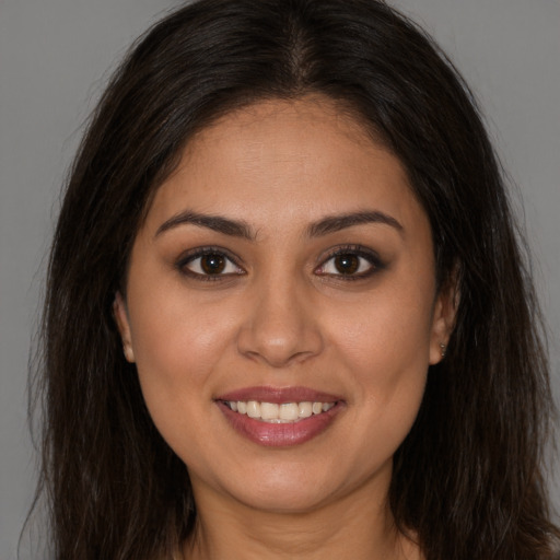 Joyful white young-adult female with long  brown hair and brown eyes