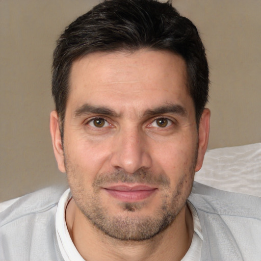 Joyful white adult male with short  brown hair and brown eyes