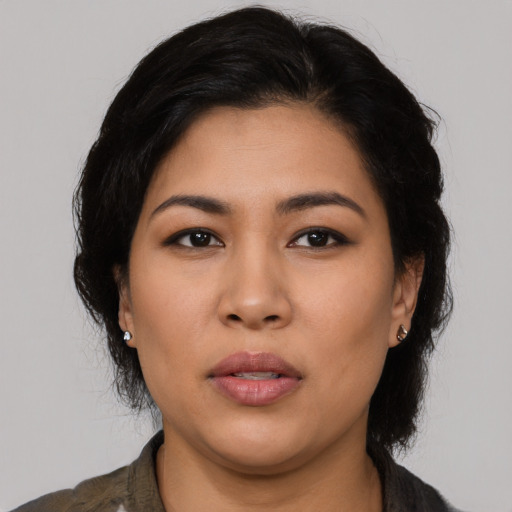 Joyful latino young-adult female with medium  black hair and brown eyes