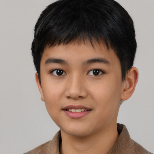 Joyful asian child male with short  black hair and brown eyes