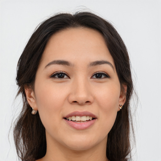 Joyful asian young-adult female with long  brown hair and brown eyes