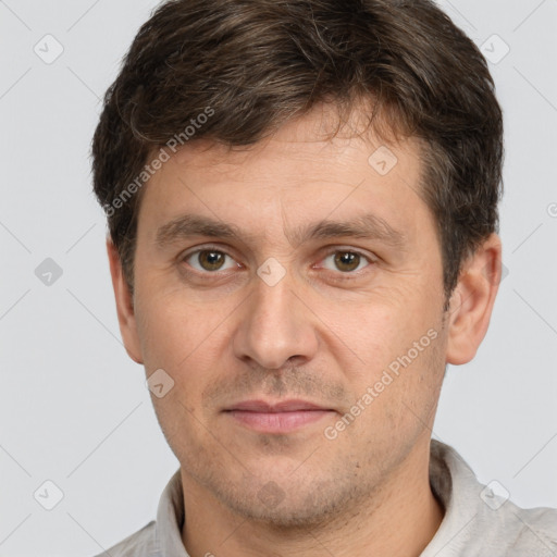 Joyful white adult male with short  brown hair and brown eyes