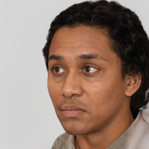 Neutral latino adult male with short  black hair and brown eyes