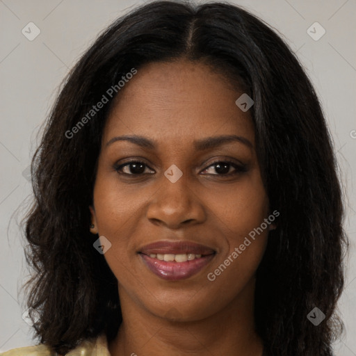 Joyful black young-adult female with long  brown hair and brown eyes