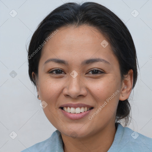 Joyful latino young-adult female with medium  brown hair and brown eyes