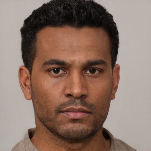Neutral latino young-adult male with short  brown hair and brown eyes
