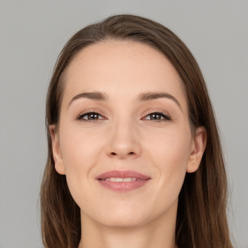 Joyful white young-adult female with long  brown hair and brown eyes