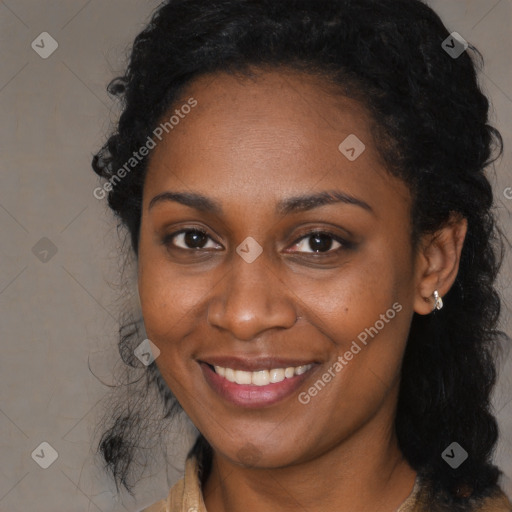 Joyful black young-adult female with long  black hair and brown eyes