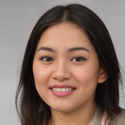 Joyful asian young-adult female with long  brown hair and brown eyes