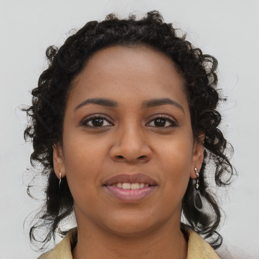 Joyful black young-adult female with medium  brown hair and brown eyes