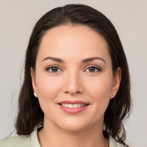 Joyful white young-adult female with medium  brown hair and brown eyes