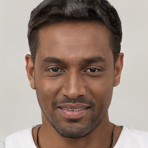 Joyful black young-adult male with short  brown hair and brown eyes