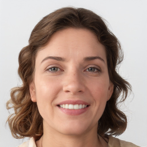 Joyful white young-adult female with medium  brown hair and blue eyes