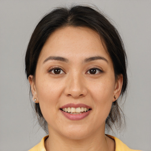 Joyful asian young-adult female with medium  brown hair and brown eyes