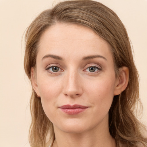 Joyful white young-adult female with long  brown hair and green eyes