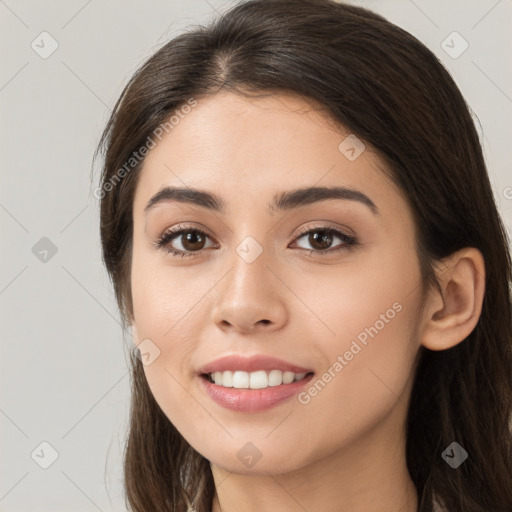 Joyful white young-adult female with long  brown hair and brown eyes