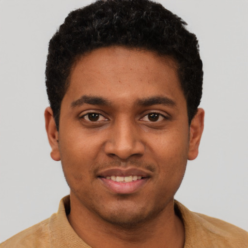 Joyful black young-adult male with short  black hair and brown eyes
