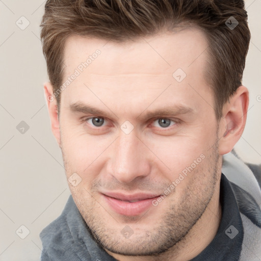 Joyful white adult male with short  brown hair and grey eyes