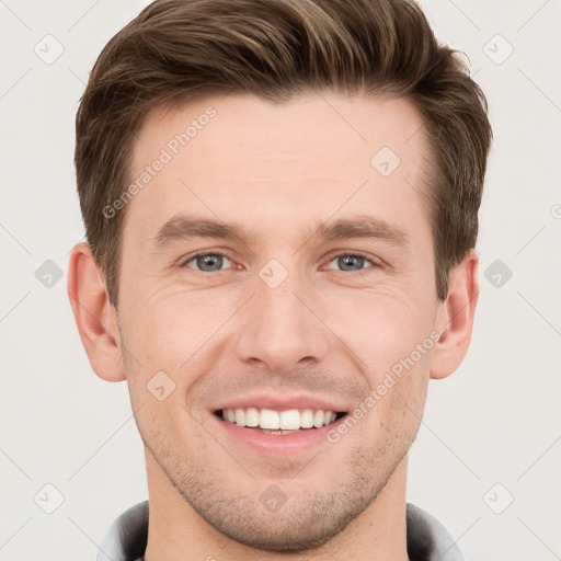 Joyful white young-adult male with short  brown hair and grey eyes