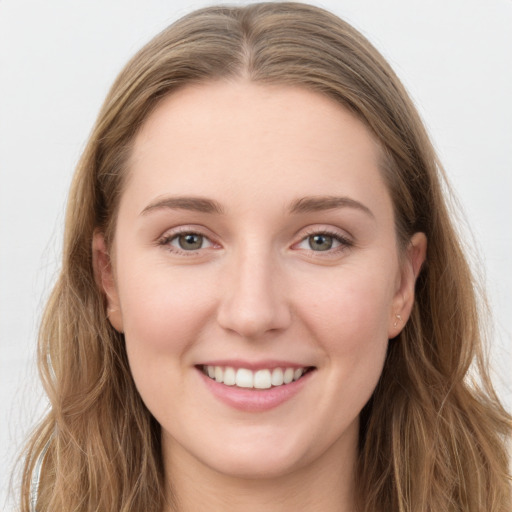 Joyful white young-adult female with long  brown hair and blue eyes