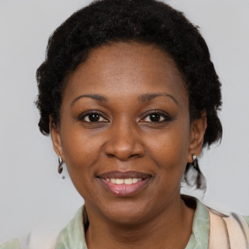 Joyful black adult female with short  black hair and brown eyes