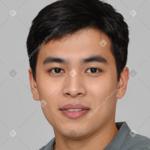 Joyful asian young-adult male with short  black hair and brown eyes