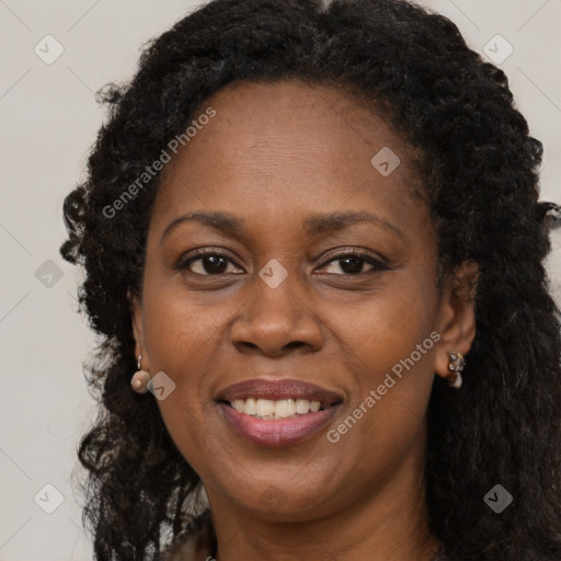 Joyful black adult female with long  brown hair and brown eyes