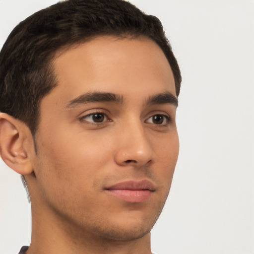 Joyful latino young-adult male with short  brown hair and brown eyes