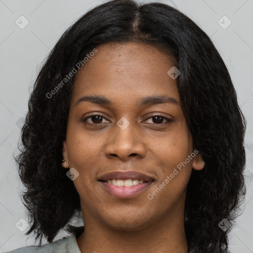 Joyful black young-adult female with long  black hair and brown eyes