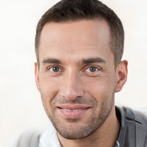 Joyful white adult male with short  brown hair and brown eyes