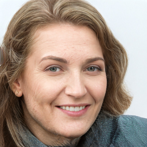 Joyful white adult female with long  brown hair and blue eyes