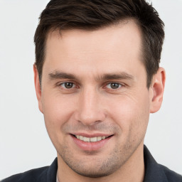 Joyful white young-adult male with short  brown hair and brown eyes