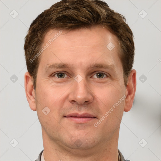 Joyful white adult male with short  brown hair and grey eyes